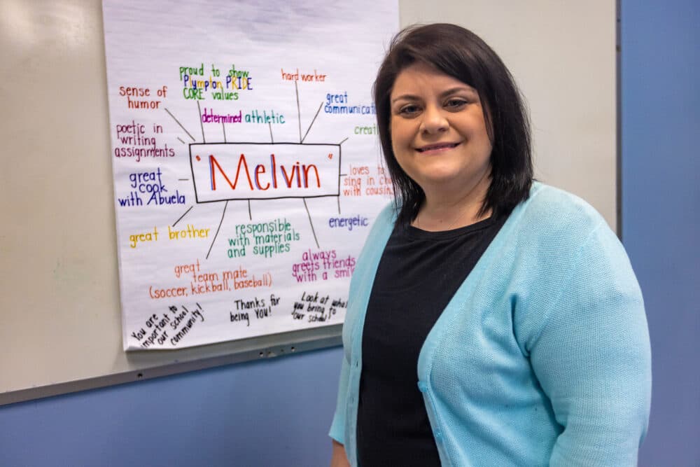 Special education teacher Meredith Lee stands in front of an example of a "strength mapping" poster that she makes during IEP meetings at Plympton Elementary School in Waltham. (Jesse Costa/WBUR)